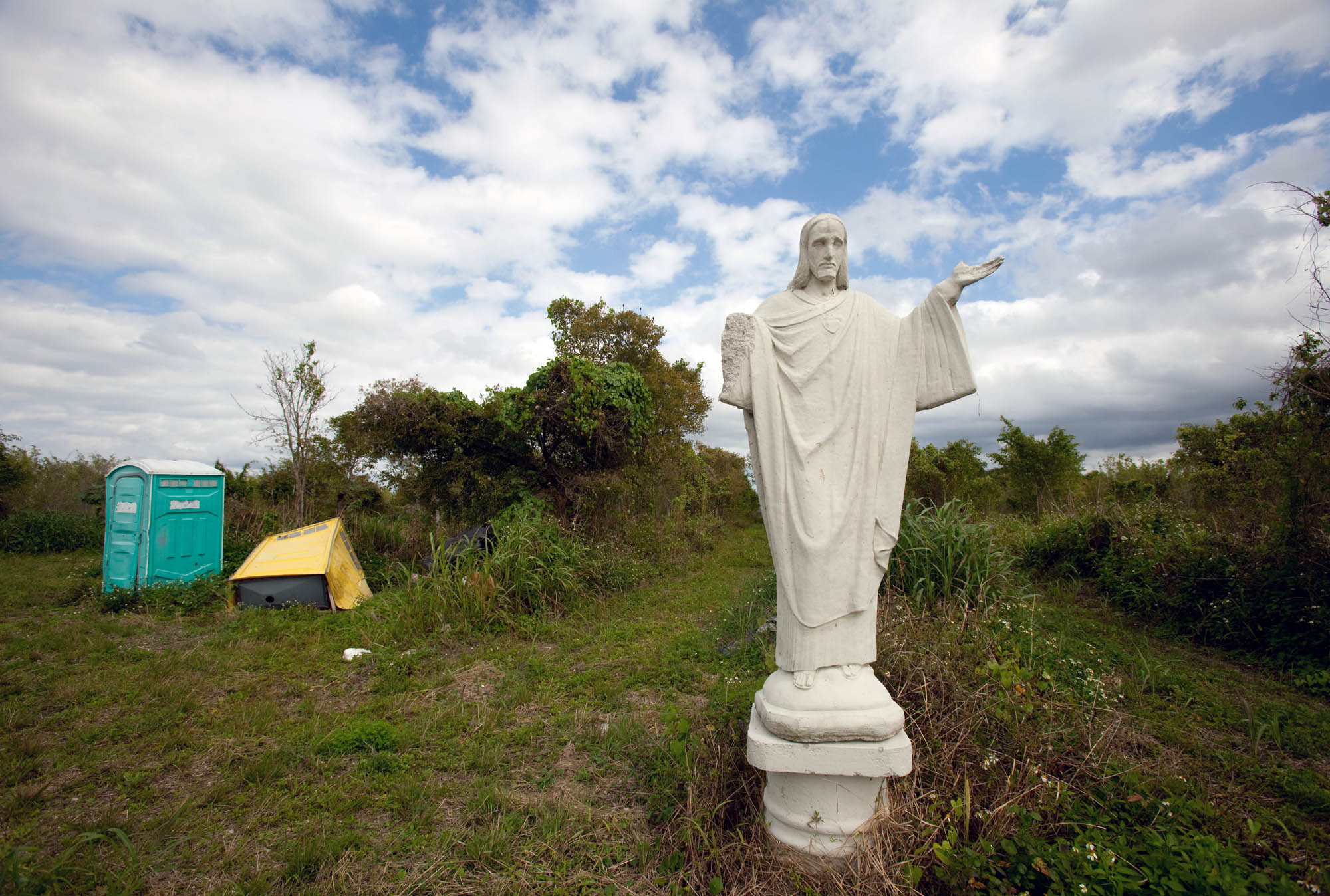 Jesus statue in abandond nursey with porta potties Florida--New Jersey Editorial Photographer