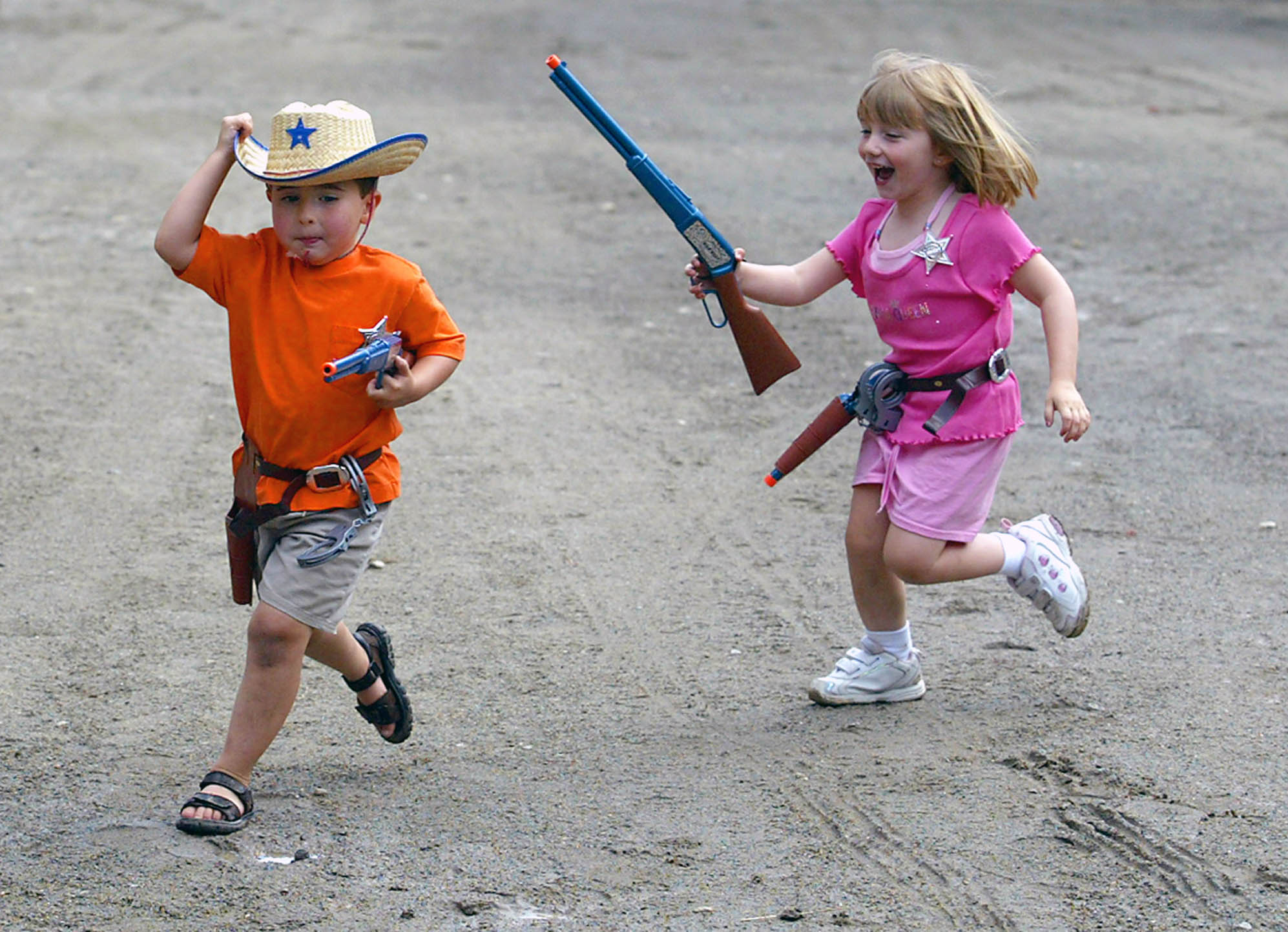 Little boy and girl playing cowboys--New Jersey Editorial Photographer