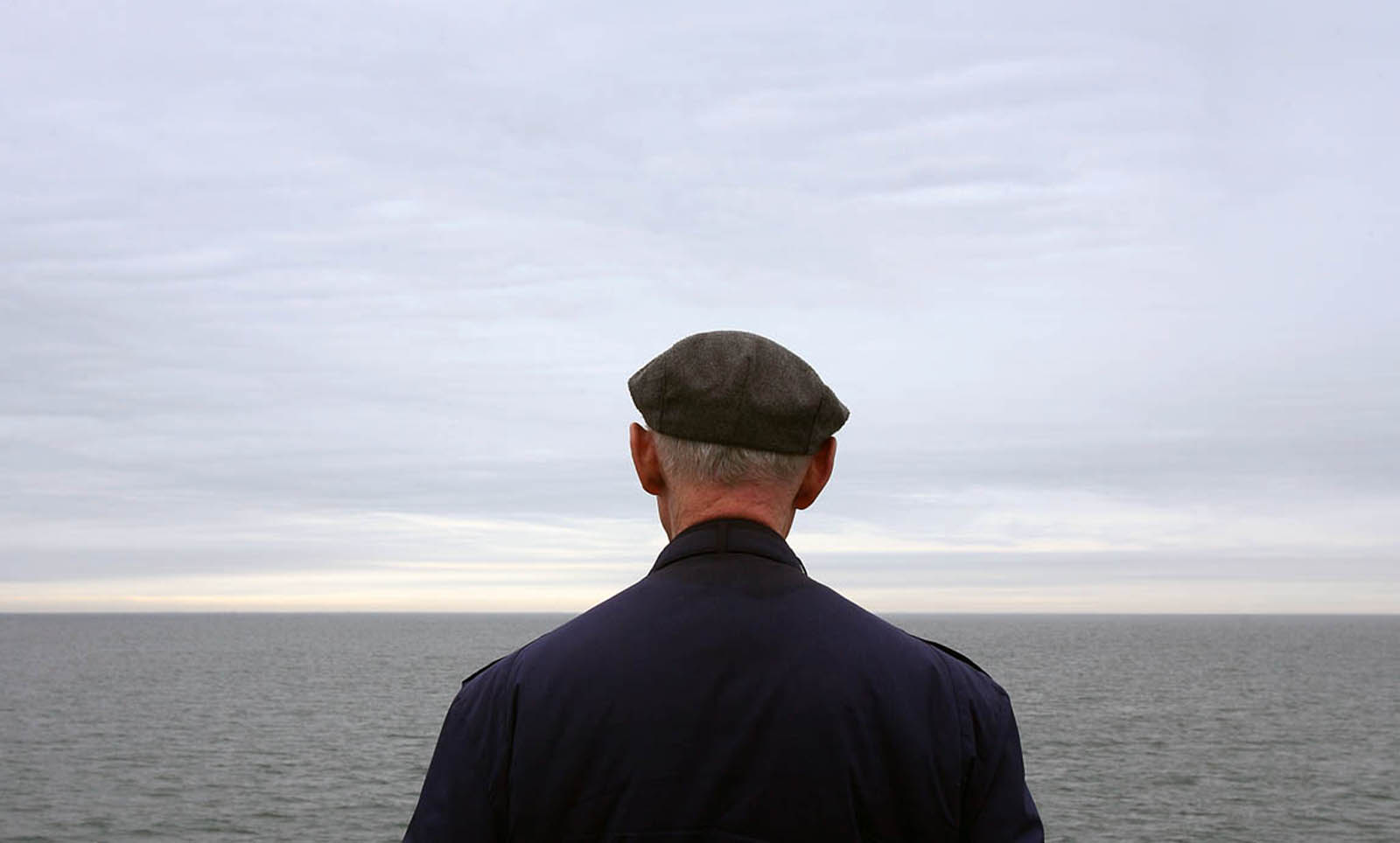 Lone old man wearing beret riding ferry--New Jersey Editorial Photographer