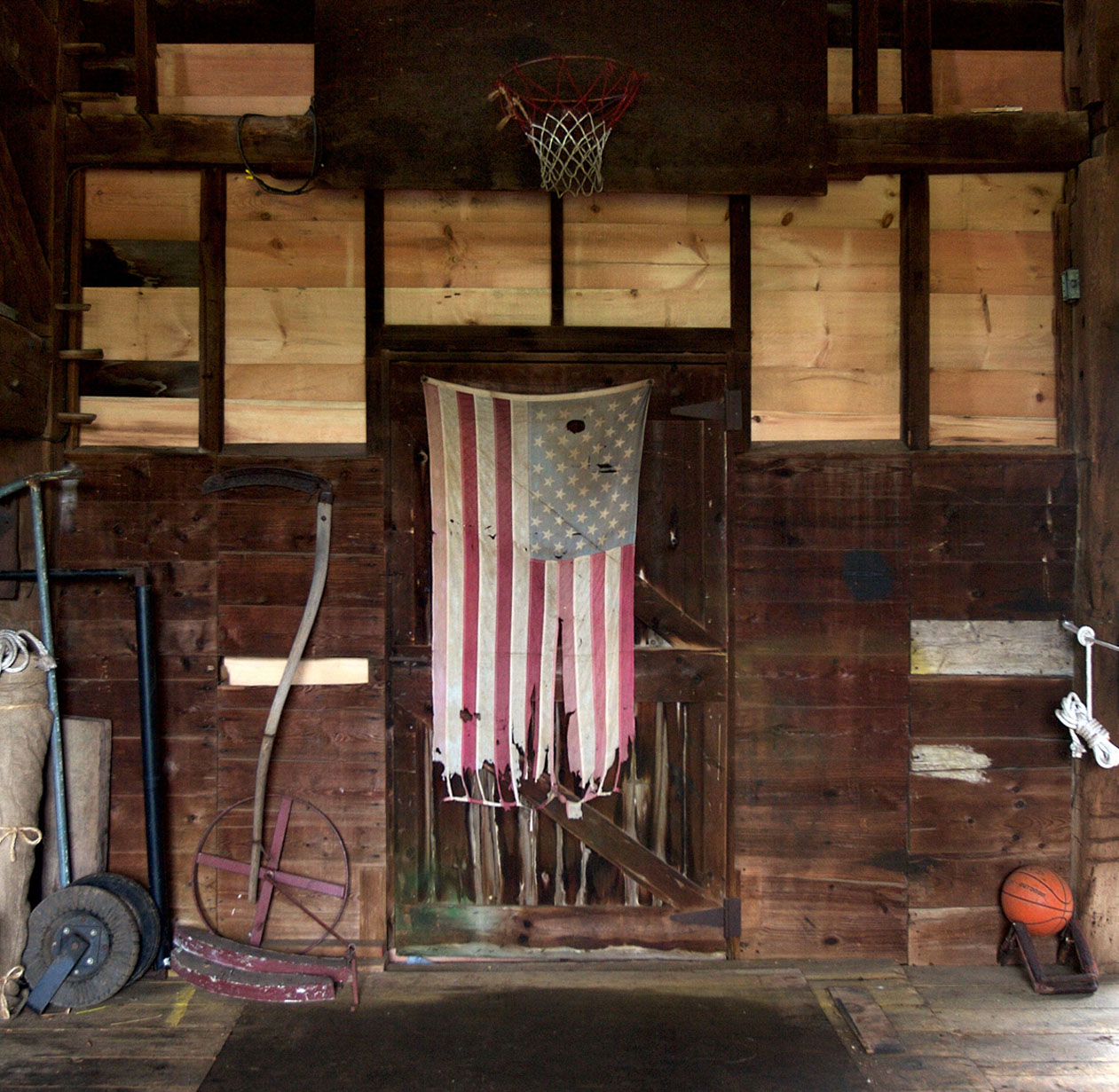 Old barn with American Flag, farm tools and basketball-New Jersey Editorial Photographer